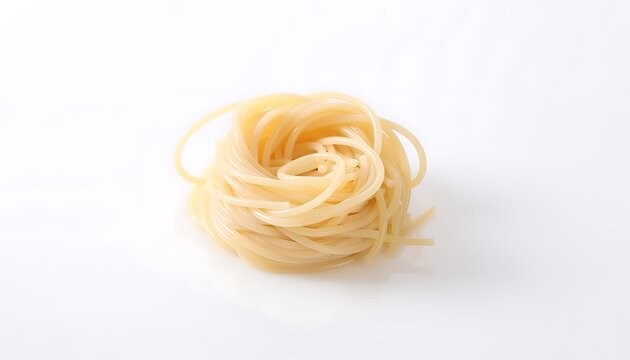 A single nest of uncooked capellini pasta on a white background.