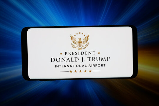 Stuttgart, Germany - 05-13-2026: In this photo illustration, the logo of President Donald J. Trump International Airport is displayed on smartphone in front of abstract background on computer screen.