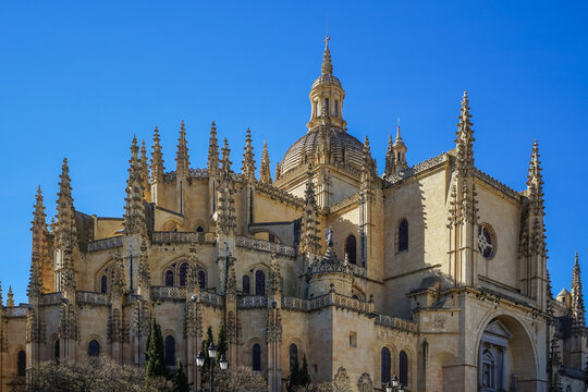 Segovia,Spain,Gothic cathedral with ornate spires and domed roof under clear blue sky