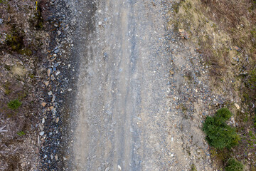 Aerial View of Rugged Gravel Road and Rocky Trail Through Forested Hills in BC Canada © edb3_16