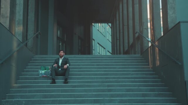 Quiet figure stands still before voyage begins, Person holding box pauses silently prior to uncertain travels
