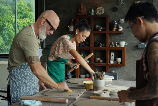 A happy couple makes ceramic plates in a workshop