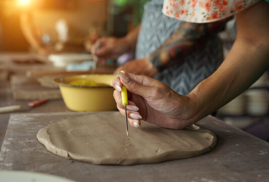 A happy couple makes ceramic plates in a workshop
