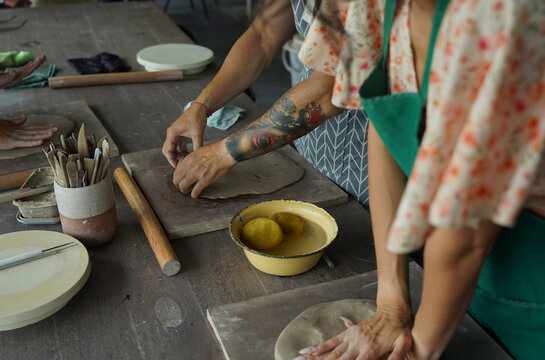 A happy couple makes ceramic plates in a workshop