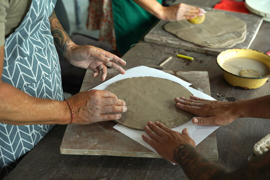 A happy couple makes ceramic plates in a workshop
