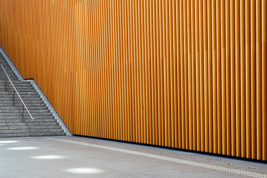 Modern Orange Slat Wall Beside Concrete Stairs