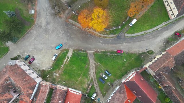 High angle view of the medieval Saschiz UNESCO fortified church in Mures, Transylvania. Gothic Saxon monument with its iconic clock tower surrounded by a scenic rural Romanian landscape.