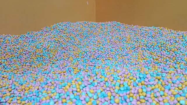 Ball pit installation in new yorks factory for vibrant, creative projects and art inspiration, suitable for presentations and design concepts.