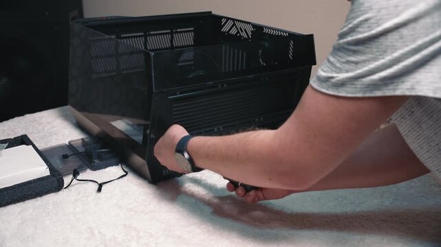 Fixing liquid cooling radiator inside computer case during personal computer assembly with careful installation and component alignment