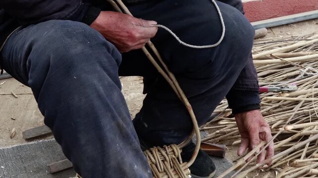 Artisan weaving handmade willow basket with natural branches