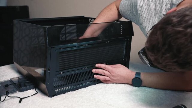 Inspecting and aligning liquid cooling radiator inside pc case before final installation and fastening during assembly