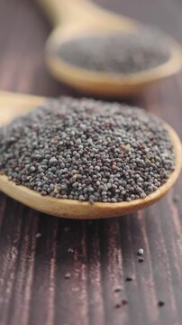 Poppy seeds on wooden spoons in a kitchen setting