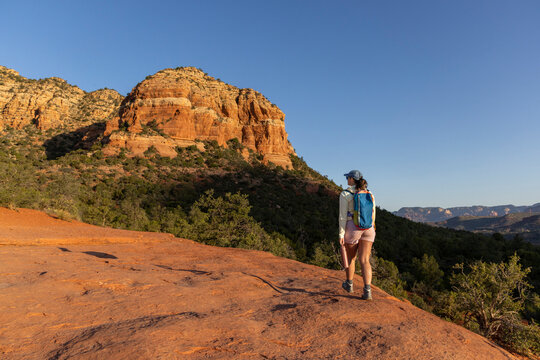 Lone woman hiking rocky mountainous wilderness trail