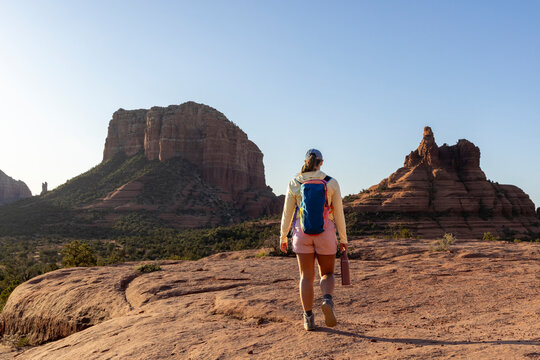 Woman hiker walking away in rocky alien environment