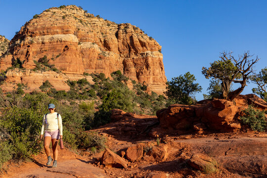 Female hiker approaching in rocky high desert environment
