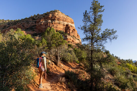 Lone woman hiker on narrow rugged high desert trail