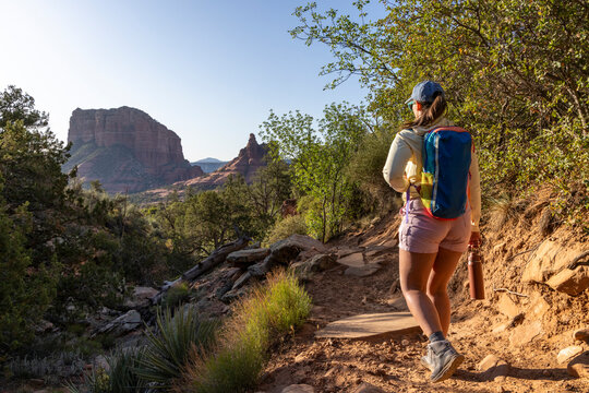 Solo female hiker on narrow rugged high desert trail