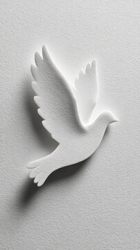 White paper dove silhouette with shadow, conceptual papercraft art of a bird in flight on textured background.