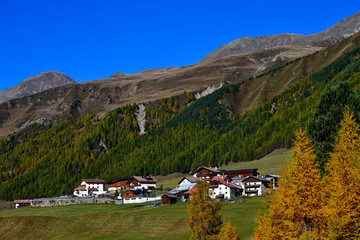 Blick über alpine Bergwiesen auf den kleinen Weiler Melag im herbstlichen Langtauferer Tal in Südtirol © Ilhan Balta