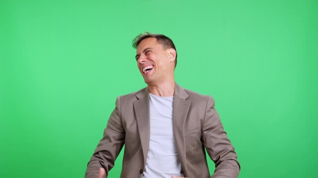 Expressive man making funny faces on green screen