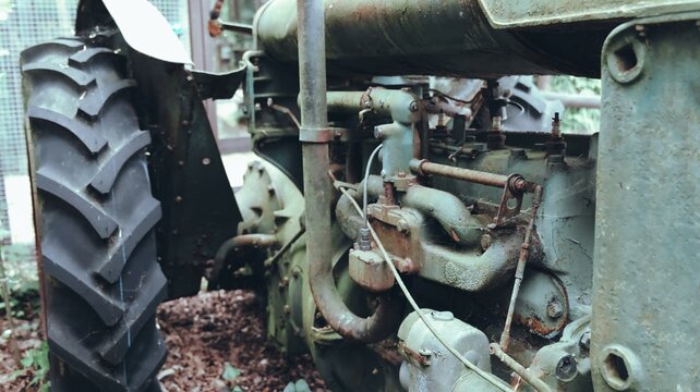 Vintage Rusty Tractor Behind Wooden Fence