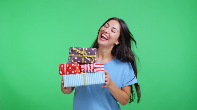 Happy smiling woman holding a stack of wrapped presents