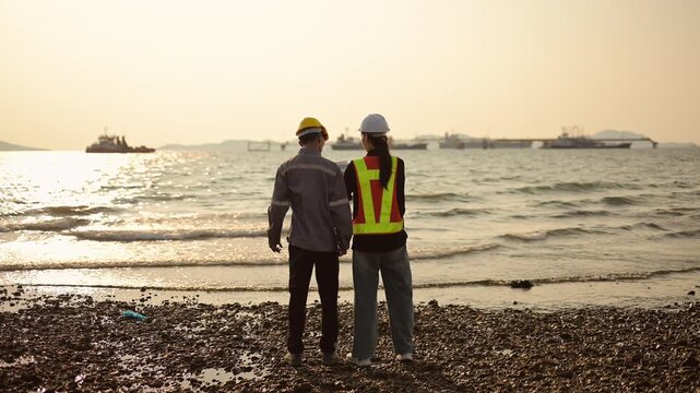 Engineers Discussing Offshore Industrial Project at Port During Sunset