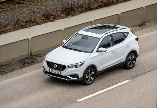 Gothenburg, Sweden - March 29 2026: White MG ZS compact crossover driving on urban roadway.