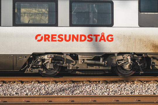 Falkenberg, Sweden - March 28 2026: Detail of Oresundstag train carriage with wheels and rail track closeup.