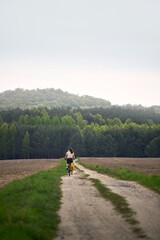 Obraz premium Happy female biker in rural nature