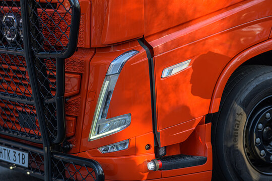 Gothenburg, Sweden - April 30 2026: Orange Volvo FH truck front detail with grille and headlight.