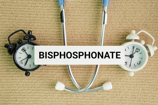 Stethoscope and paper with the word bisphosphonate. a class of medications that prevent and treat bone loss.
