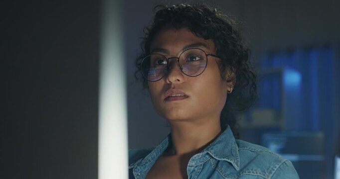 Close-up Black female programmer with code reflection in glasses working late in home office at night. Cybersecurity, AI algorithm, Network security, software developer, serious face, burnout concept.