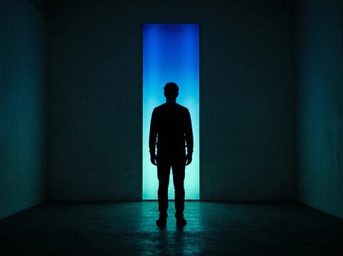 Mysterious Dark Silhouette of a Man Standing Alone in Front of a Futuristic Glowing Neon Blue Vertical Light Portal Doorway