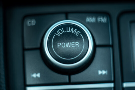 Close up of car audio system control panel with volume and power button