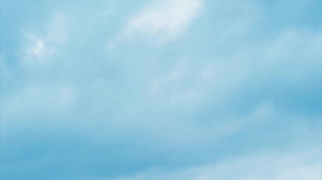Beautiful white clouds moving shining through fog in blue sky, white clouds 4K stock footage. flight over the clouds with strong wind amazing cloudscape. 