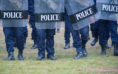 Fototapeta premium Riot police control the crowd practice and review on the grass field.
