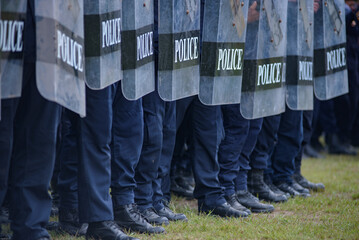 Fototapeta premium Riot police control the crowd practice and review on the grass field.