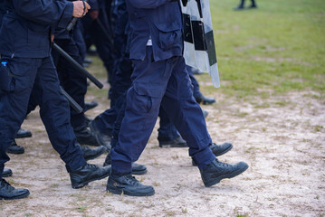 Fototapeta premium Riot police control the crowd practice and review on the grass field.