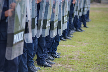 Fototapeta premium Riot police control the crowd practice and review on the grass field.