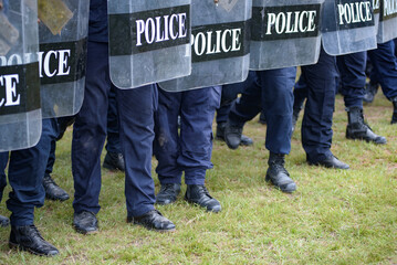 Fototapeta premium Riot police control the crowd practice and review on the grass field.