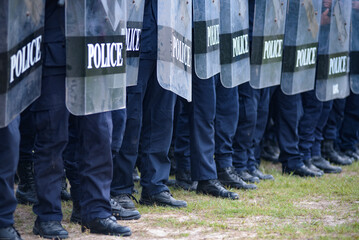 Fototapeta premium Riot police control the crowd practice and review on the grass field.