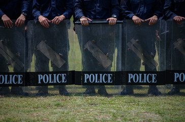 Fototapeta premium Riot police control the crowd practice and review on the grass field.