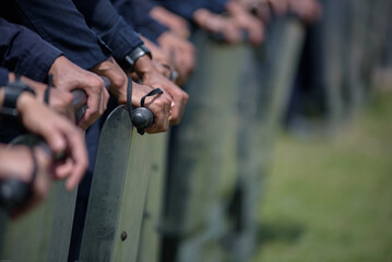 Fototapeta premium Riot police control the crowd practice and review on the grass field.
