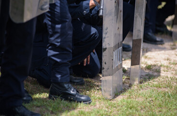 Fototapeta premium Riot police control the crowd practice and review on the grass field.