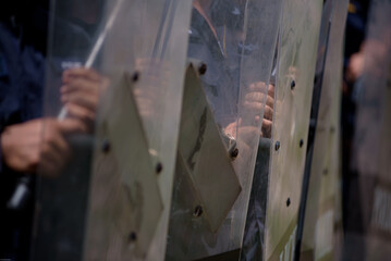 Fototapeta premium Riot police control the crowd practice and review on the grass field.