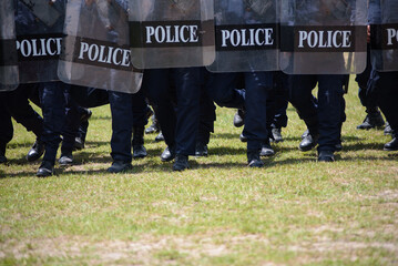 Fototapeta premium Riot police control the crowd practice and review on the grass field.