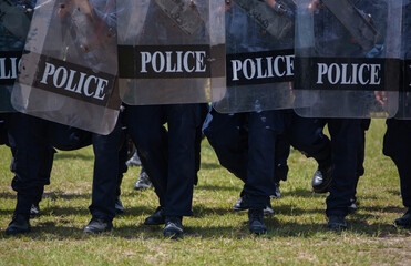 Fototapeta premium Riot police control the crowd practice and review on the grass field.
