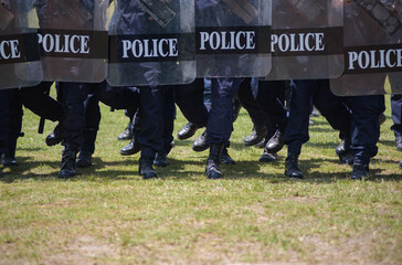 Fototapeta premium Riot police control the crowd practice and review on the grass field.