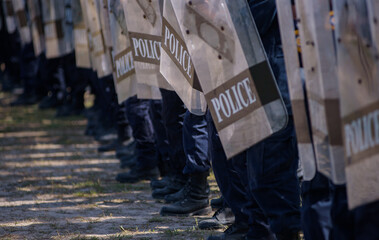 Fototapeta premium Riot police control the crowd practice and review on the grass field.